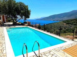 a swimming pool with a view of the water at Villa Galini in Astros