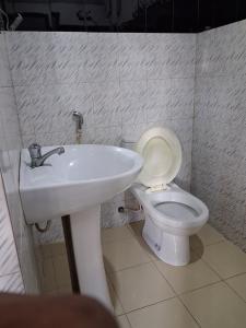 a bathroom with a white sink and a toilet at Villa Ocean Gift in Galle