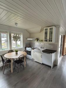 a kitchen with a table and a dining room at Loftesnes in Sogndal