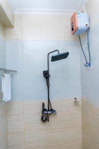 a walk in shower with a keyboard on the wall at Fortis Hill Hotel in Arusha +113 photos