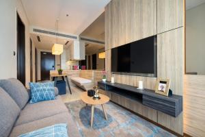 a living room with a couch and a flat screen tv at Dao By Dorsett Puteri Cove in Johor Bahru