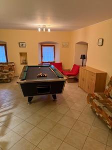 a living room with a pool table in it at Apartmány Kamermann in Hroznětín +13 photos