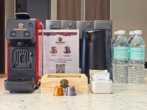 a coffee maker sitting on a counter with bottles of water at Dao By Dorsett Puteri Cove in Johor Bahru +12 photos