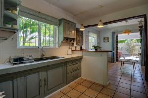 a kitchen with a sink and a counter top at Marine House Pointe d'Esny in Blue Bay