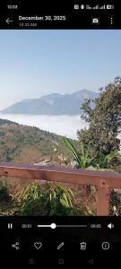 a view of a view of a mountain from a bench at DEVITHAN Resort in Dharān Bāzār