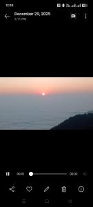 a screenshot of a computer screen with a sunset at DEVITHAN Resort in Dharān Bāzār