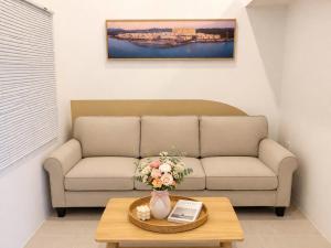 a living room with a couch and a table at Machy Home in Phú Quốc