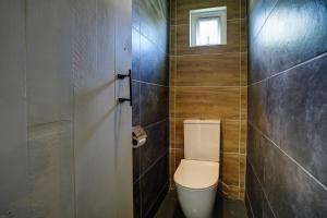 a bathroom with a toilet and a window at Marine House Pointe d'Esny in Blue Bay +23 photos