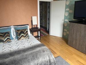 a bedroom with a bed and a flat screen tv at BAE SUITE 5 min walk to bae systems in Barrow in Furness