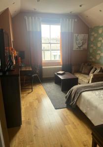 a bedroom with a bed and a desk and a window at BAE SUITE 5 min walk to bae systems in Barrow in Furness +8 photos