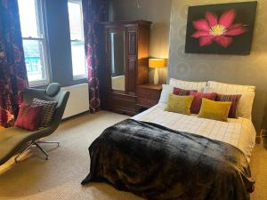 a bedroom with a bed and a chair in it at BAE SUITE 5 min walk to bae systems in Barrow in Furness