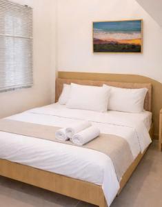 a bedroom with a bed with two towels on it at Machy Home in Phú Quốc +13 photos