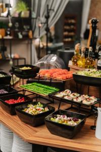 a buffet of different types of food on a table at Hotel Tarnovia in Tarnów