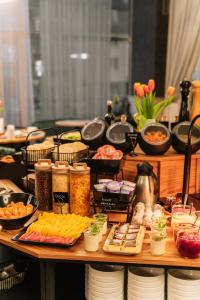 a buffet of food on a table with food at Hotel Tarnovia in Tarnów