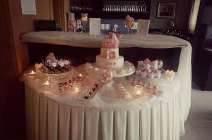 a table with a wedding cake and cupcakes on it at Hotel AGAVA in Neum