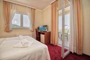 a hotel room with a bed and a large window at Hotel AGAVA in Neum +32 photos