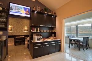 a kitchen with a table and a dining room at Hotel AGAVA in Neum