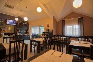 a dining room with wooden tables and chairs at Hotel AGAVA in Neum