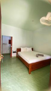 a bedroom with a bed in a room at Mango Lodge in Gili Gede
