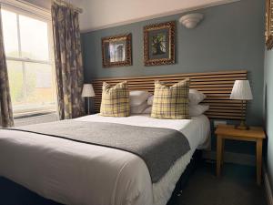 a bedroom with a large bed and a window at The Royal Oak Ripon in Ripon