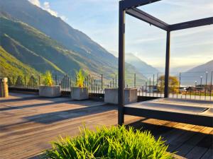 a wooden deck with a view of a mountain at Maritsch I Apartments in Naturno
