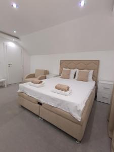 a bedroom with a large bed with two pillows on it at Prenociste T-07 in Smederevo