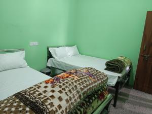 a room with two beds in a room at Cloud Hill Homestay in Jālāpahār