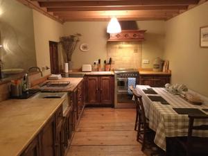 a kitchen with a table and a sink and a stove at Skip To The Zipwire in Bethesda