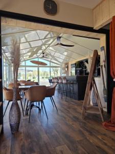 a kitchen and dining room with a table and chairs at Camping Val de Boutonne in Saint-Jean-dʼAngély