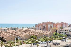 an aerial view of a city with buildings and the ocean at Patacona By The Beach in Valencia