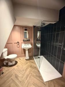 a bathroom with a shower and a toilet and a sink at The Royal Oak Ripon in Ripon