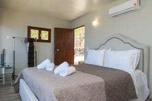 a bedroom with a bed with towels on it at Villa Selas Kalymnos in Kalymnos
