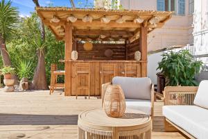 a patio with a gazebo and a table at Villa Claudia Hotel Cannes Centre - Parking in Cannes