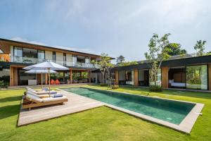 an exterior view of a house with a swimming pool at Uluwatu Zen Villas in Badung