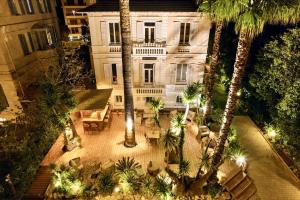 an aerial view of a building with palm trees at Villa Claudia Hotel Cannes Centre - Parking in Cannes