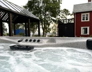 a hot tub in a yard with snow on the ground at Apartment at NerSalberg Farm in Røra, Inderøy in Røra
