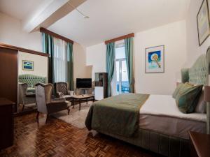 a bedroom with a bed and a living room at Dome Hotel in Kyrenia