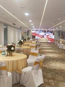 a banquet hall with tables and chairs and flowers at Keys Lite by Lemon Tree Hotels, Urban Square, Udaipur in Udaipur