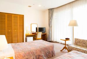 Postel nebo postele na pokoji v ubytování Kobe Hotel Fruit Flower + 37 fotografií