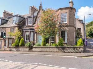 an old house on the corner of a street at Rowan Tree House in Brechin