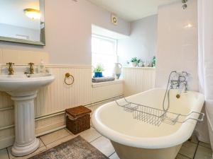 a bathroom with a sink and a bath tub and a sink at Rowan Tree House in Brechin +58 photos