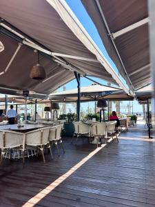 a patio with tables and chairs under a canopy at Alex Residence in Larnaca