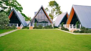 a large building with a green lawn in front of it at Paraiso Del Bacnotan in Bacnotan