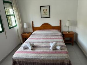 a bedroom with a bed with two pillows on it at Apartamentos Torrelaguna in Vera +36 photos