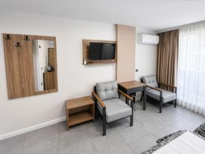 a hotel room with a table and chairs and a television at D'Premium in Edirne