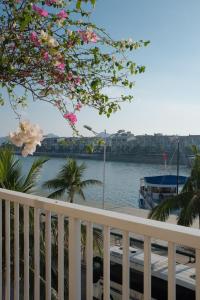 a balcony with a view of the water and a boat at Lam Home Tuần Châu in Ha Long