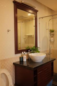 a bathroom with a sink and a mirror at Lam Home Tuần Châu in Ha Long +12 photos