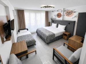 a hotel room with two beds and a couch at D'Premium in Edirne