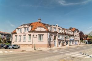 a large building on the corner of a street at Hotel Varazdin in Varaždin