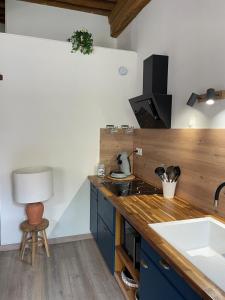 a kitchen with a counter top with a sink and a table at Studio cosy -Hyper centre -Tout à pied in Paray-le-Monial +8 photos